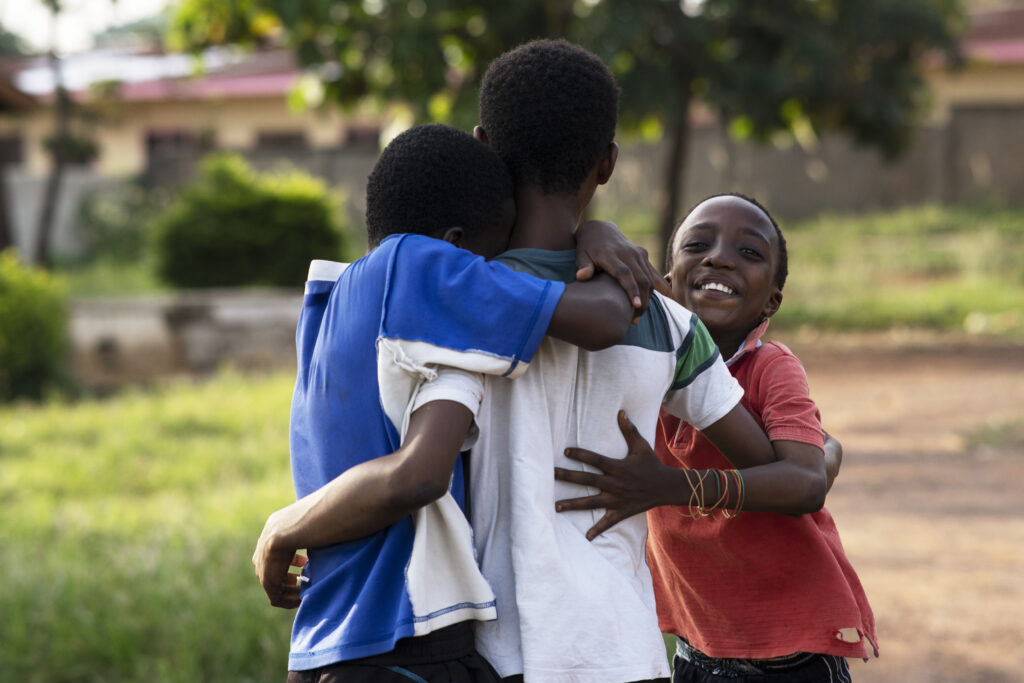 happy friends hugging medium shot